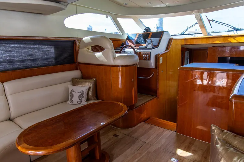Slide: The Image of Luxurious 2002 Dyna 50 yacht interior with plush seating and elegant wooden finishes. - 22