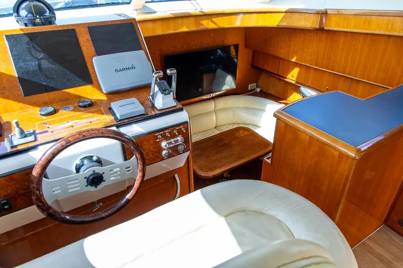 Slide: The Image of Luxurious 2002 Dyna 50 yacht interior with wood finish and modern navigation equipment. - 23
