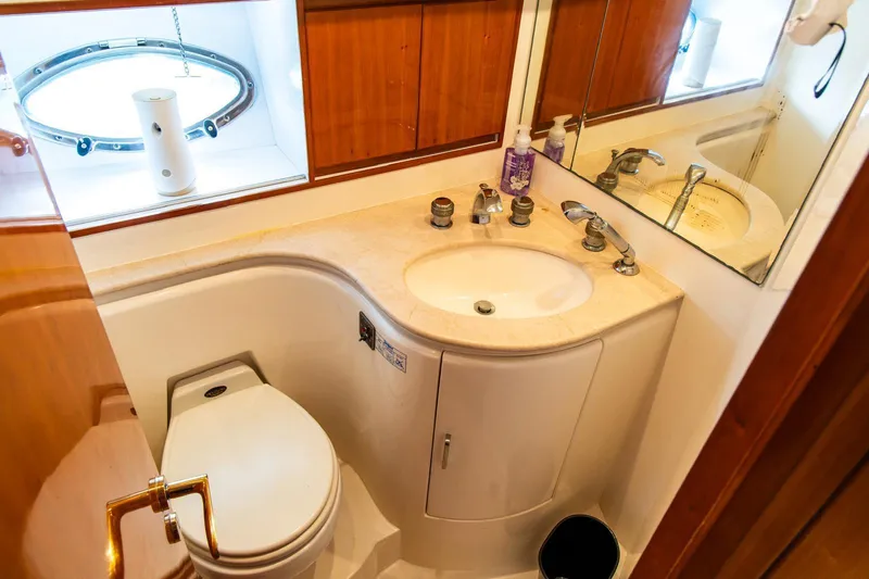 Slide: The Image of Luxurious bathroom in 2002 Dyna 50 yacht with sink, toilet, and mirror. - 27