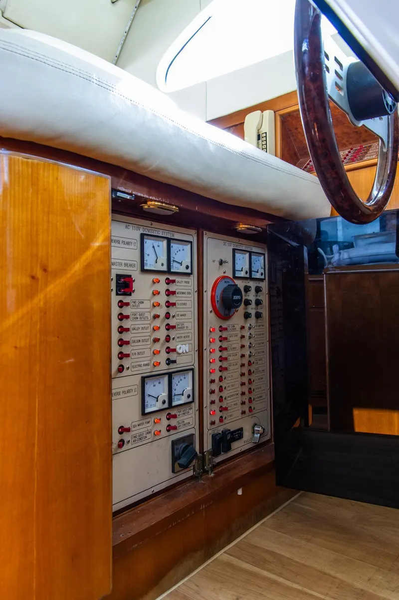 Slide: The Image of Control panel of a 2002 Dyna 50 yacht with gauges and switches. - 32