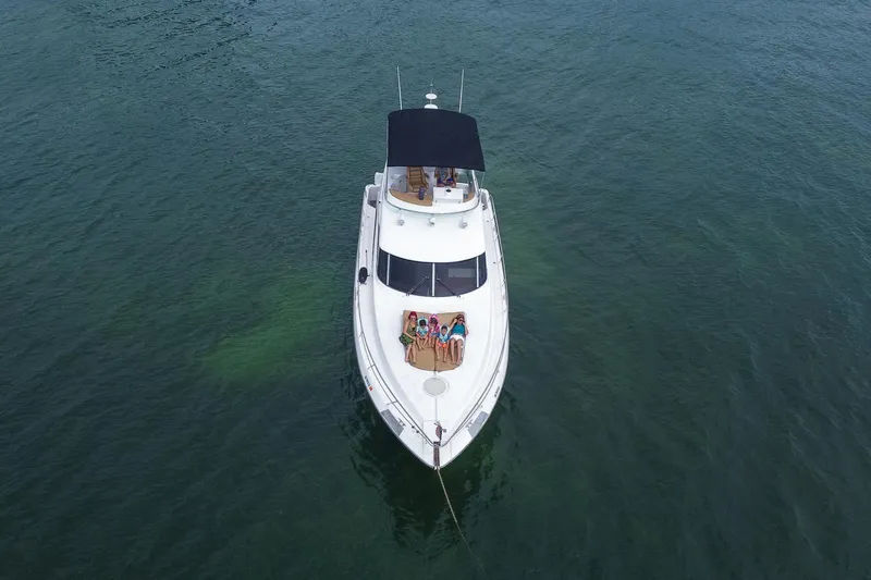 Slide: The Image of Aerial view of 2002 Dyna 50 yacht with people relaxing on deck. - 6