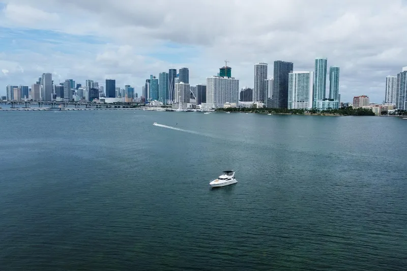 Slide: The Image of Boat on water with city skyline in background, cloudy sky, Dyna 50, 2002 model. - 7