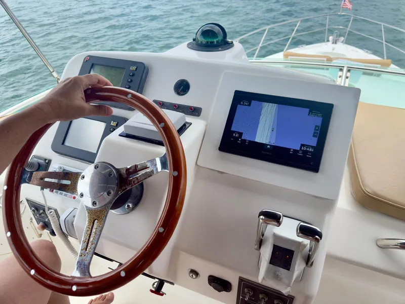 Slide: The Image of Boat helm with wooden steering wheel and navigation screens, Dyna 50, 2002 model. - 8