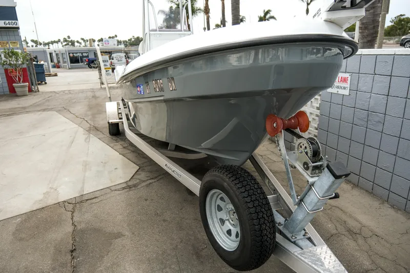 Slide: The Image of 2022 Banks Panga 24 boat on trailer, parked outdoors near a building. - 10