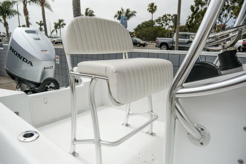 Slide: The Image of 2022 Banks Panga 24 boat interior with Honda 140 outboard motor and white seating. - 11