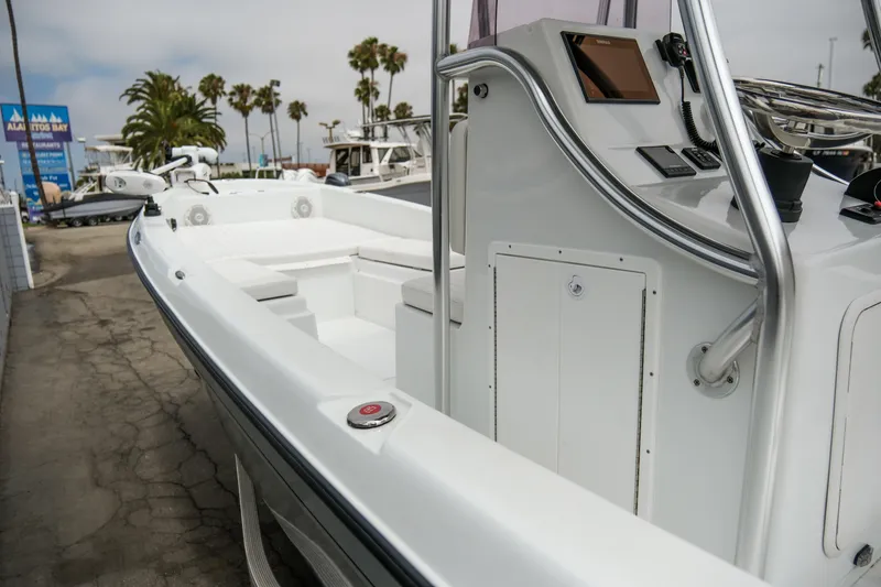 Slide: The Image of 2022 Banks Panga 24 boat, white interior, docked near palm trees and marina. - 12