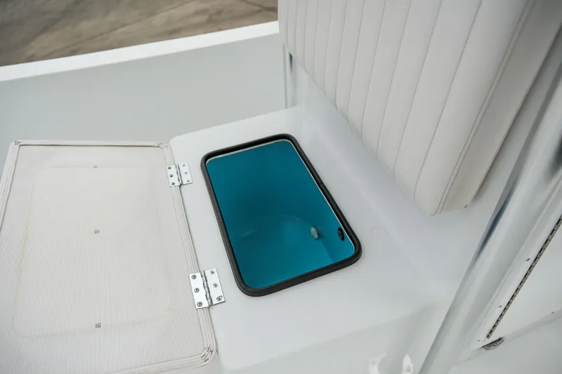 Slide: The Image of 2022 Banks Panga 24 boat storage compartment with open lid and blue interior. - 14