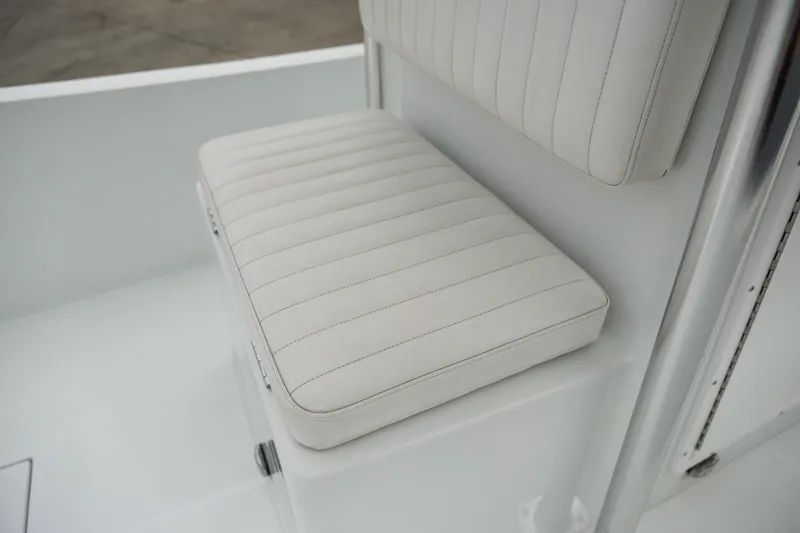 Slide: The Image of White cushioned seat on 2022 Banks Panga 24 boat interior. - 15