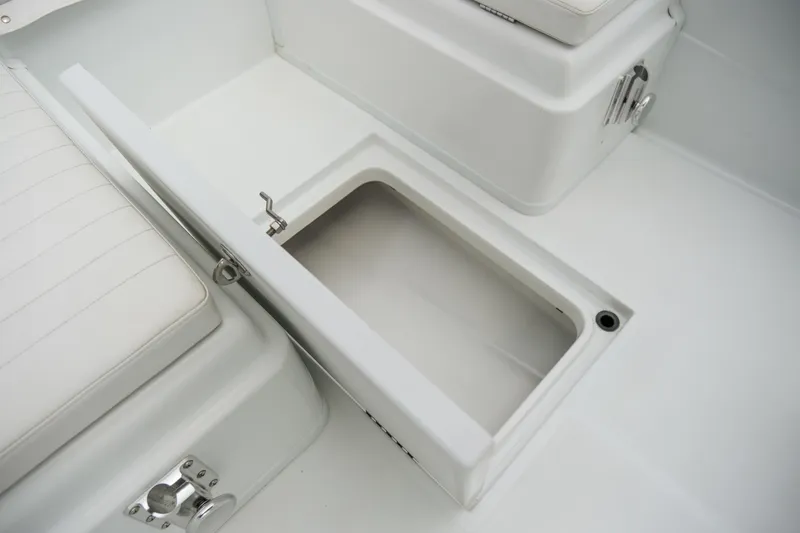 Slide: The Image of Open storage compartment on 2022 Banks Panga 24 boat, featuring white seating and sleek design. - 17