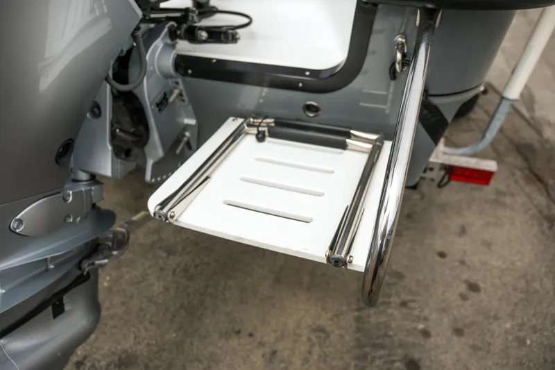 Slide: The Image of Rear view of 2022 Banks Panga 24 boat with stainless steel swim ladder. - 18