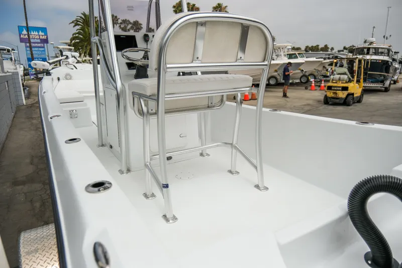 Slide: The Image of 2022 Banks Panga 24 boat interior with seating and control console at a marina. - 4