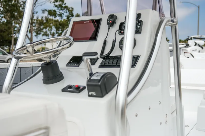 Slide: The Image of Control console of a 2022 Banks Panga 24 boat with steering wheel and navigation equipment. - 5