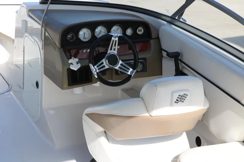 Slide: The Image of 2008 Four Winns 224 Funship boat cockpit with steering wheel and gauges. - 13