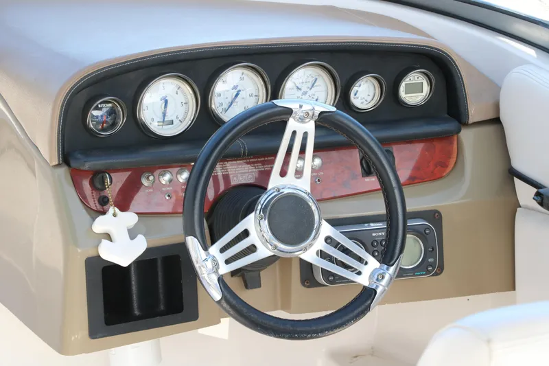 Slide: The Image of Dashboard of a 2008 Four Winns 224 Funship boat with steering wheel and gauges. - 14