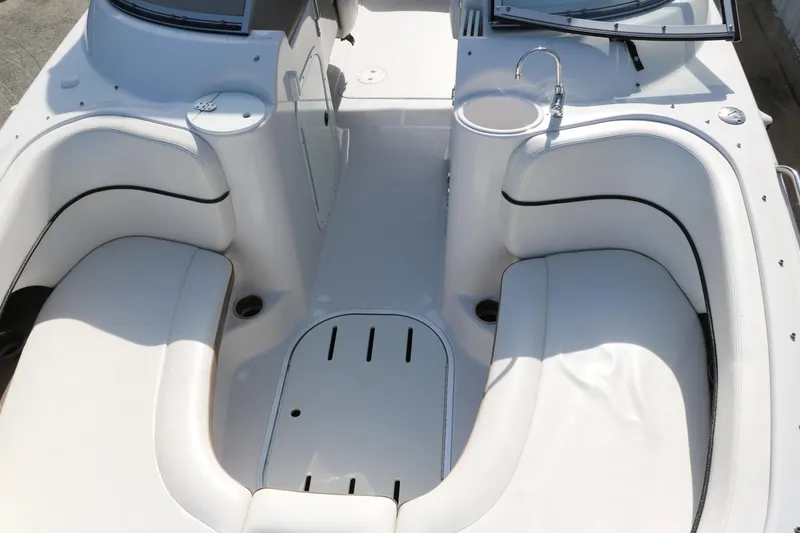 Slide: The Image of 2008 Four Winns 224 Funship boat interior with white seating and built-in sink. - 17