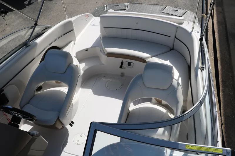 Slide: The Image of 2008 Four Winns 224 Funship boat interior with white seating and steering wheel. - 20