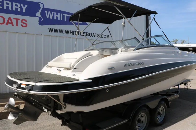 Slide: The Image of 2008 Four Winns 224 Funship boat with black and white exterior, displayed on a trailer. - 3