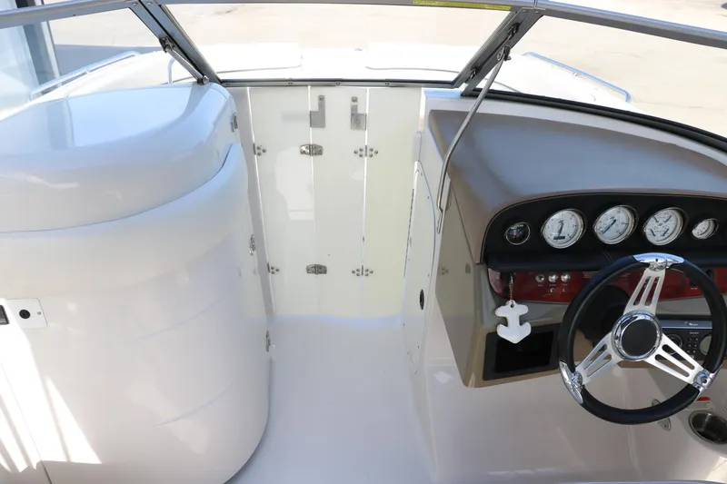 Slide: The Image of 2008 Four Winns 224 Funship boat dashboard with steering wheel and gauges. - 30