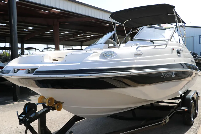 Slide: The Image of 2008 Four Winns 224 Funship boat on trailer, under a covered storage area. - 8