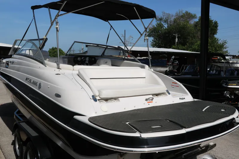 Slide: The Image of 2008 Four Winns 224 Funship boat with canopy, docked outdoors. - 9
