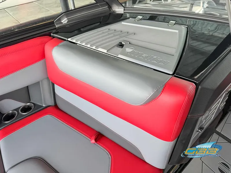 Slide: The Image of 2019 Malibu M235 interior with red and gray seating, cup holders, and sleek design. - 19