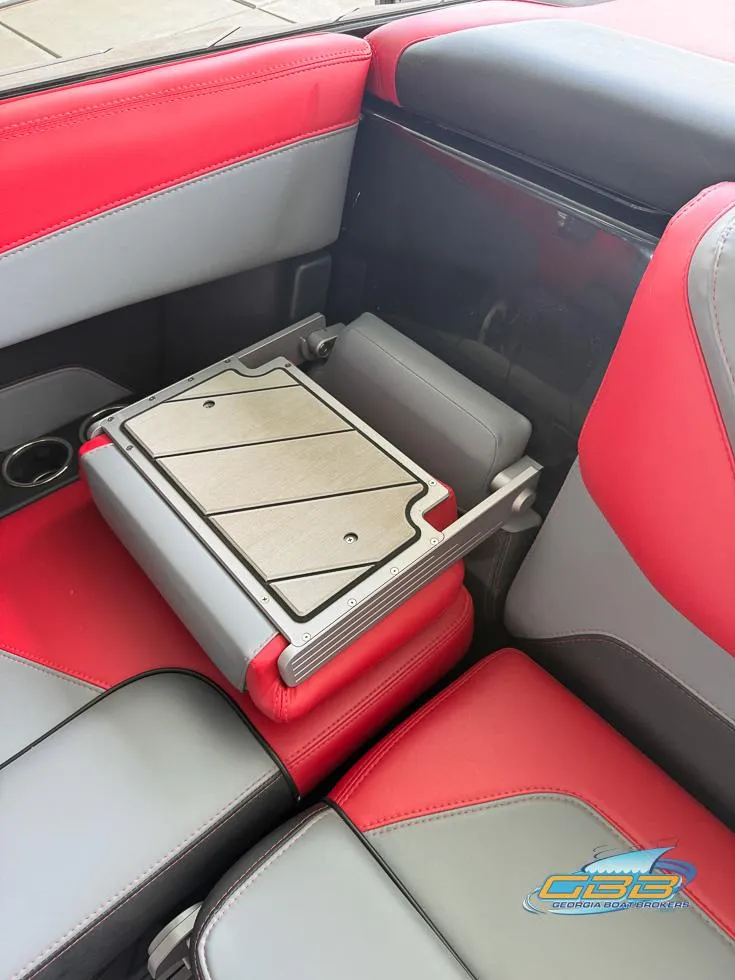 Slide: The Image of Red and gray interior of a 2019 Malibu M235 boat with a foldable table. - 20