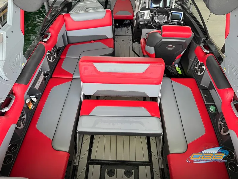 Slide: The Image of 2019 Malibu M235 boat interior with red and gray seating, modern dashboard, and sleek design. - 21