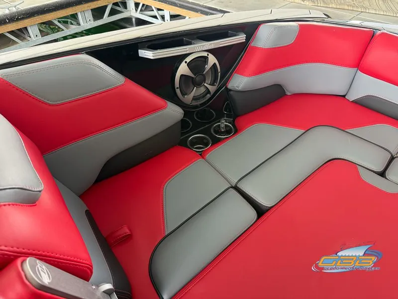 Slide: The Image of Red and gray interior of 2019 Malibu M235 boat with speaker and cup holders. - 26
