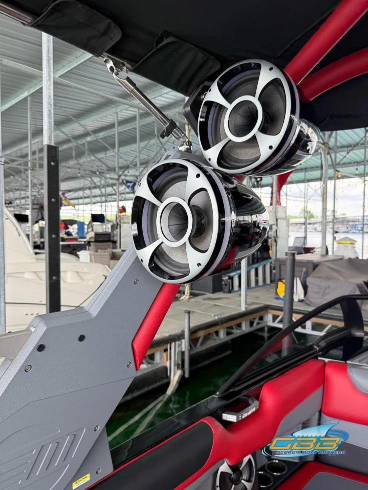 Slide: The Image of 2019 Malibu M235 boat with premium speakers at a marina. - 33