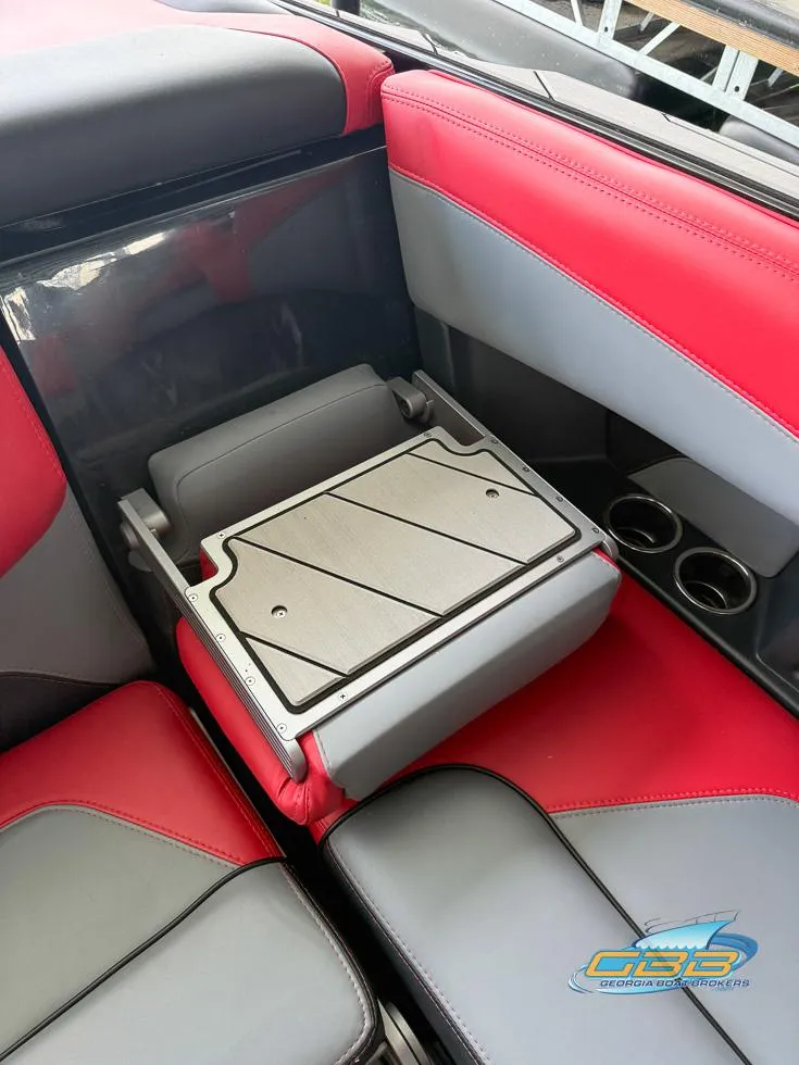 Slide: The Image of Red and gray interior of 2019 Malibu M235 boat with storage compartment. - 35