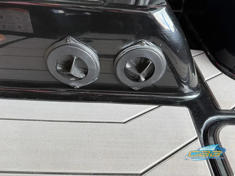 Slide: The Image of Close-up of 2019 Malibu M235 boat's dual exhaust vents on sleek black surface. - 37
