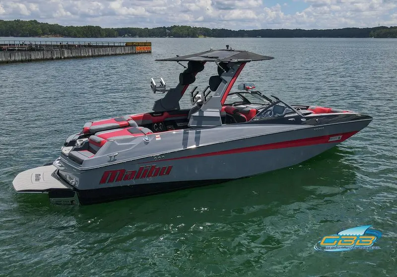 Slide: The Image of 2019 Malibu M235 boat on a lake, featuring sleek design and red accents. - 5