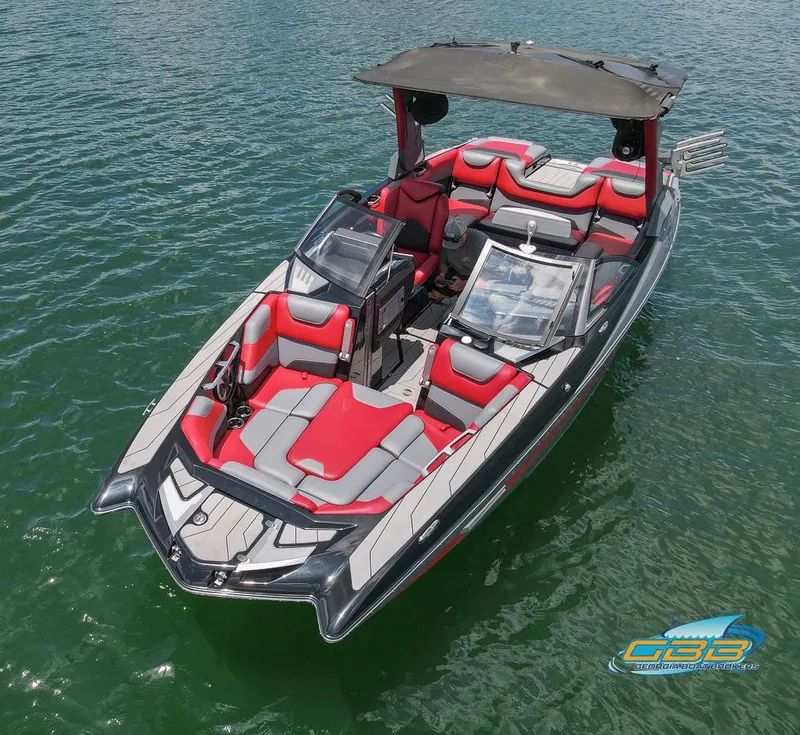 Slide: The Image of 2019 Malibu M235 boat with red and gray seating on water. - 9