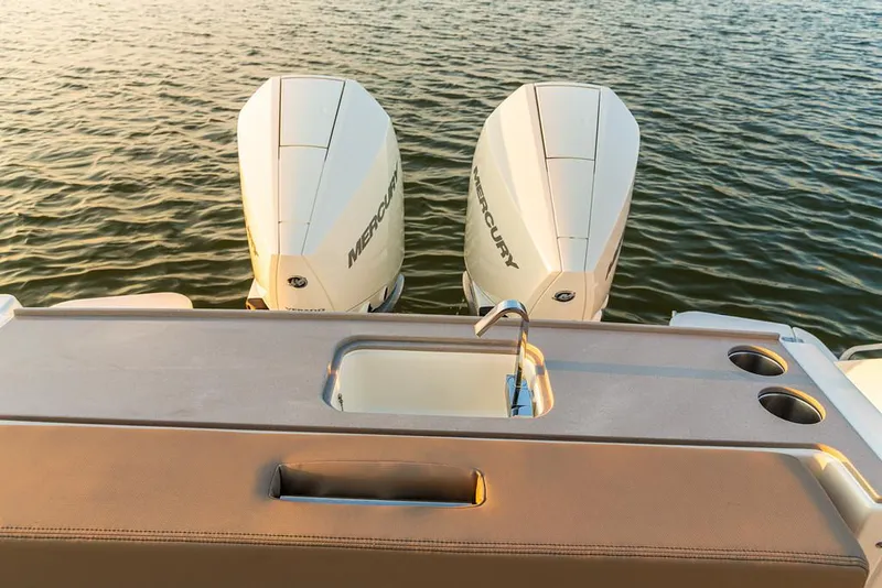 Slide: The Image of 2026 Boston Whaler 330 Vantage boat with dual Mercury engines and cushioned seating. - 13
