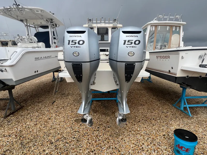 Slide: The Image of Twin Honda 150 VTEC outboard engines on a 2021 Defiance Admiral 250 EX boat. - 17