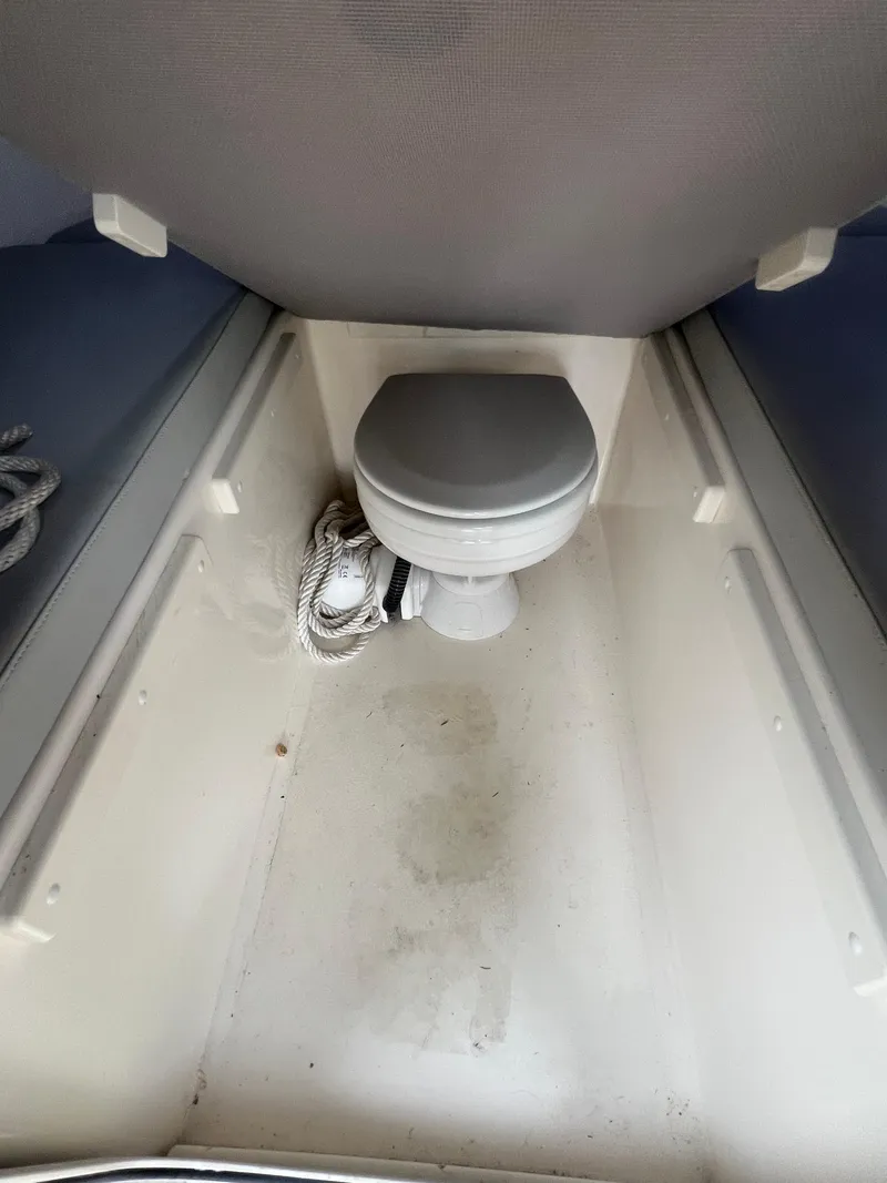 Slide: The Image of Interior of 2021 Defiance Admiral 250 EX boat with a compact toilet. - 23