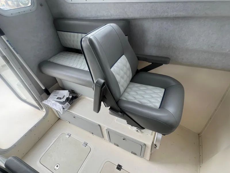 Slide: The Image of Captain's chair in 2021 Defiance Admiral 250 EX boat interior. - 25