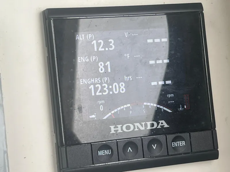 Slide: The Image of Honda engine display showing voltage, temperature, and engine hours on Defiance Admiral 250 EX. - 29