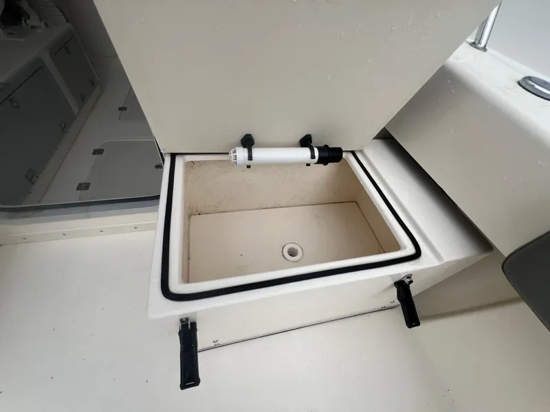 Slide: The Image of Open storage compartment on 2021 Defiance Admiral 250 EX boat. - 34