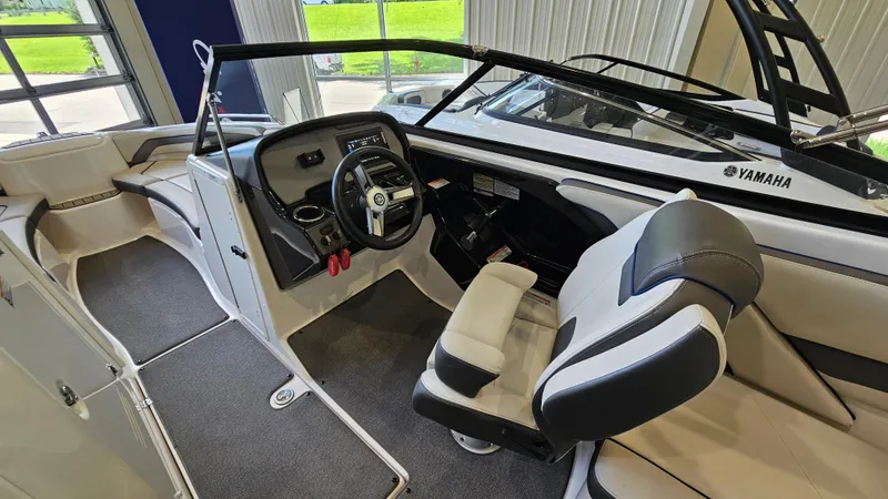Slide: The Image of 2020 Yamaha Boats SX240 interior with steering wheel and seating. - 13