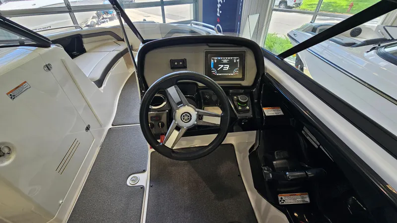 Slide: The Image of 2020 Yamaha Boats SX240 cockpit with steering wheel and digital display. - 14