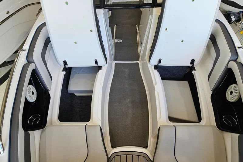 Slide: The Image of 2020 Yamaha Boats SX240 interior with open storage compartments and seating. - 21