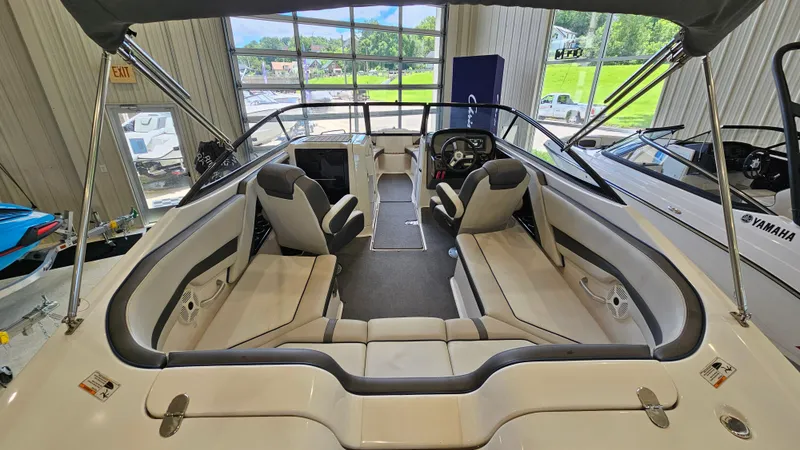 Slide: The Image of 2020 Yamaha Boats SX240 interior with seating and steering wheel in showroom. - 6