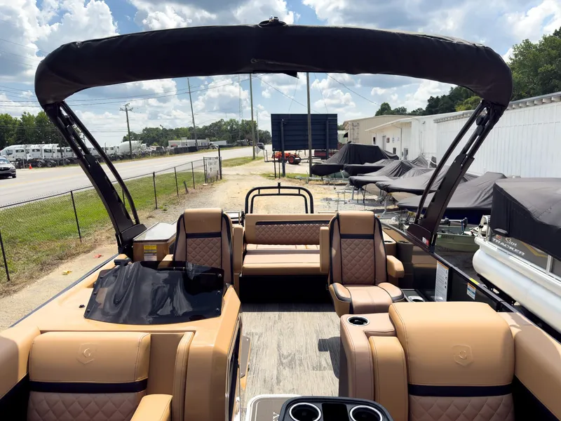 Slide: The Image of Dashboard of 2026 Godfrey AquaPatio 23' Tritoon with illuminated controls and audio system. - 11