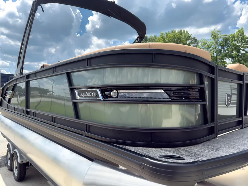 Slide: The Image of Control panel and illuminated cup holder on 2026 Godfrey AquaPatio 23' Flip Lounge Tritoon. - 12