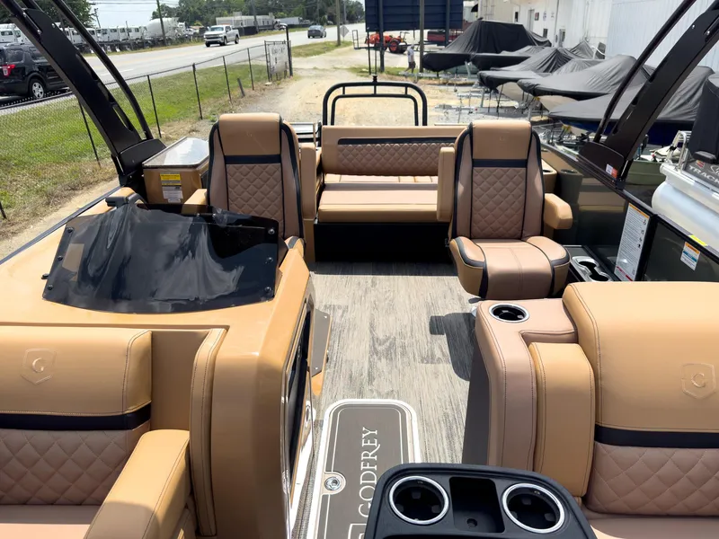 Slide: The Image of Open storage compartment on 2026 Godfrey AquaPatio 23' Flip Lounge Tritoon boat. - 13