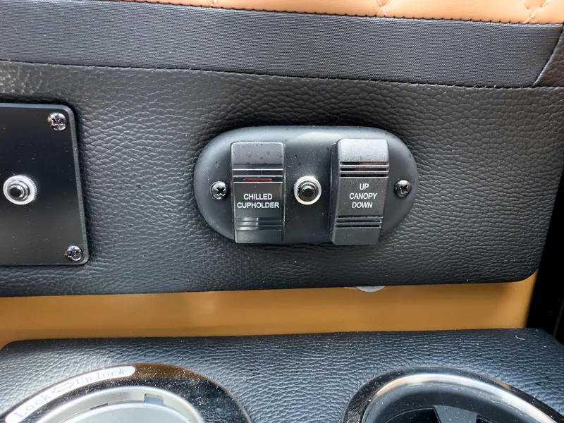 Slide: The Image of Control panel with chilled cupholder and canopy switches on 2026 Godfrey AquaPatio Tritoon. - 51