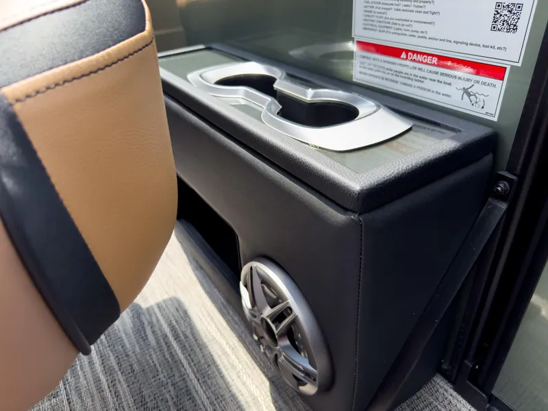 Slide: The Image of Cup holders and speaker on 2026 Godfrey AquaPatio 23' Flip Lounge Tritoon boat interior. - 53