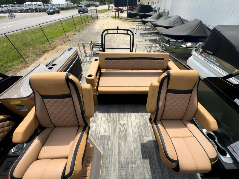Slide: The Image of Interior of 2026 Godfrey AquaPatio 23' Flip Lounge Tritoon with luxurious tan seating. - 56