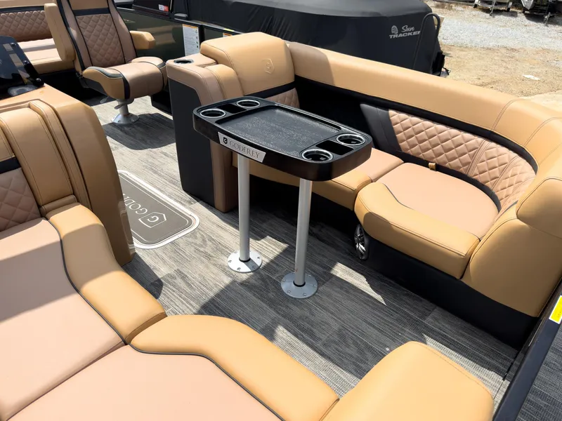 Slide: The Image of 2026 Godfrey AquaPatio 23' Flip Lounge Tritoon with luxurious seating and table display. - 6